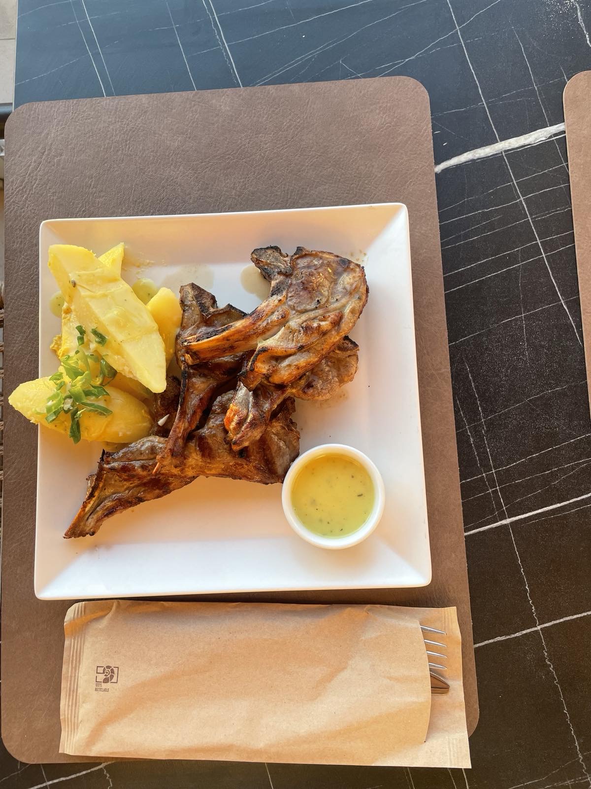 Grilled lamb chops with potatoes and herb sauce at Tramonto